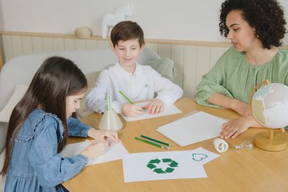 Crianças aprendem sobre reciclagem com uma professora durante atividade educativa em sala de aula.